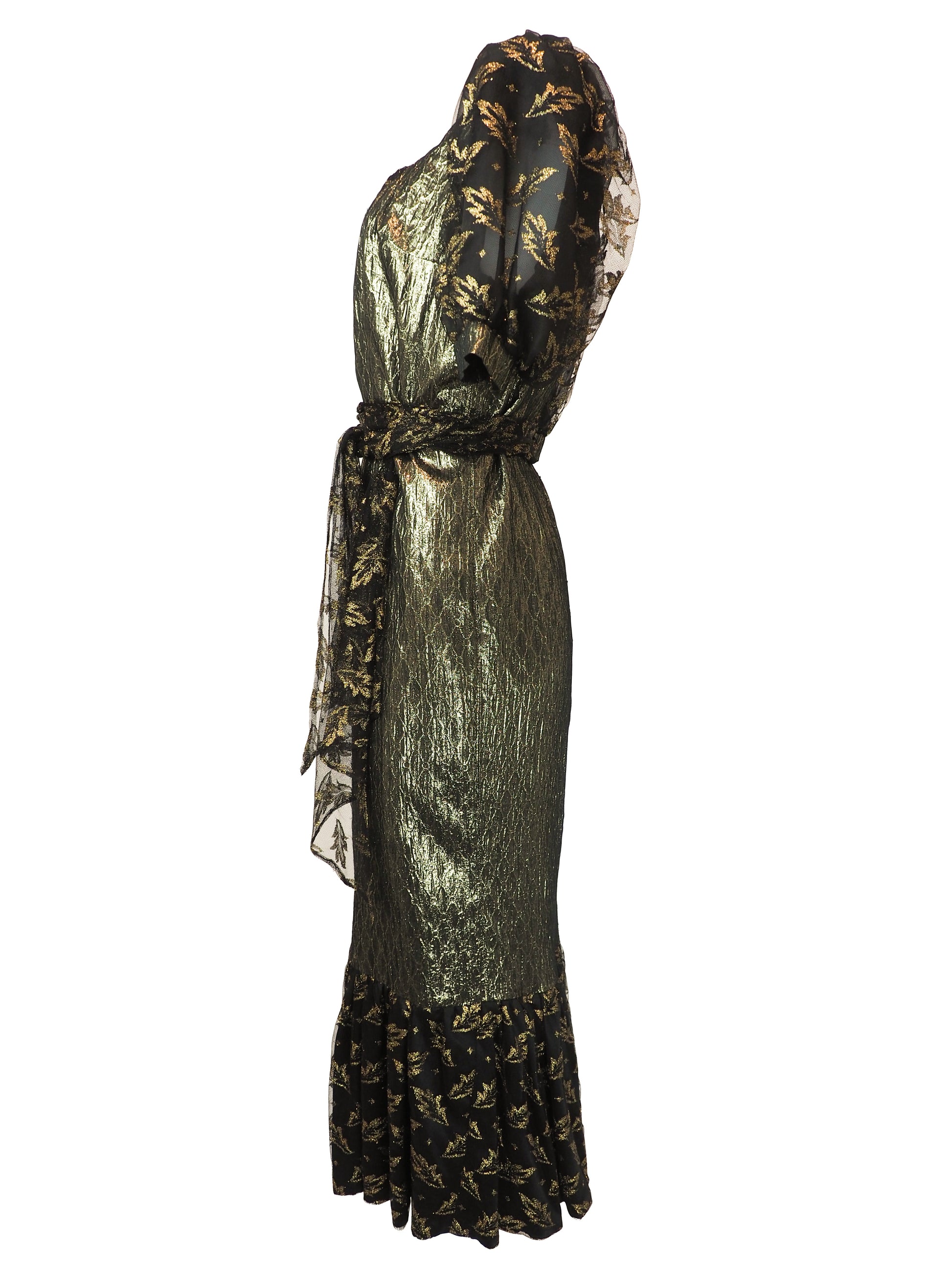 A vintage 1980s metallic gold and black patterned midi dress with puff sleeves, a matching waist tie, and a ruffled hem