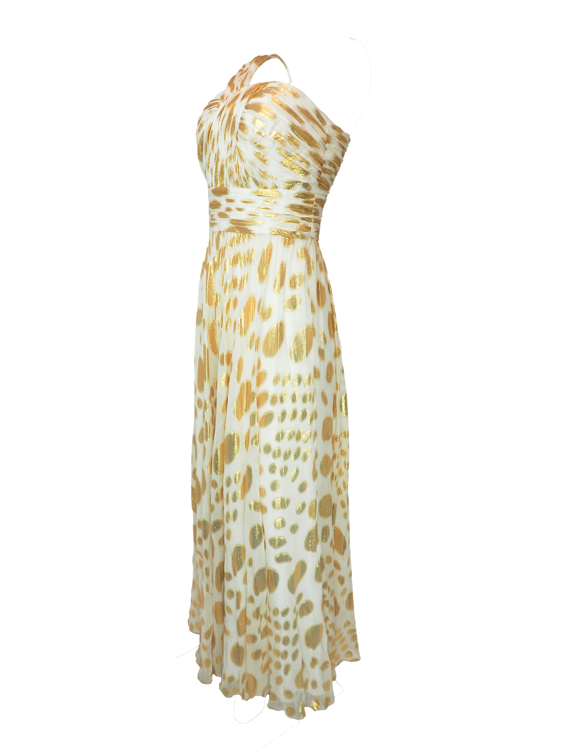 A vintage halter-neck maxi dress with a gold and cream animal print pattern, featuring a ruched bodice and a flowing skirt.