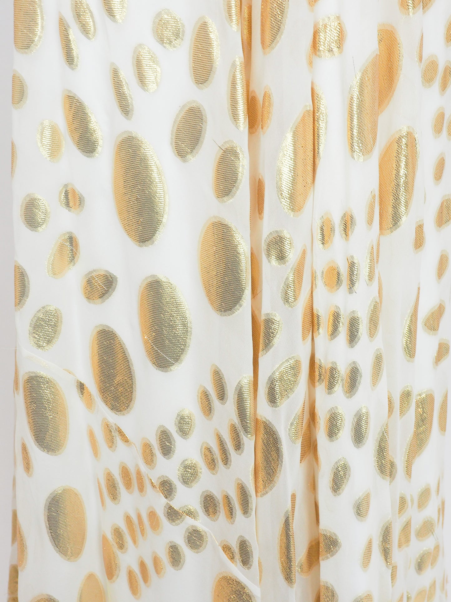 A vintage halter-neck maxi dress with a gold and cream animal print pattern, featuring a ruched bodice and a flowing skirt.