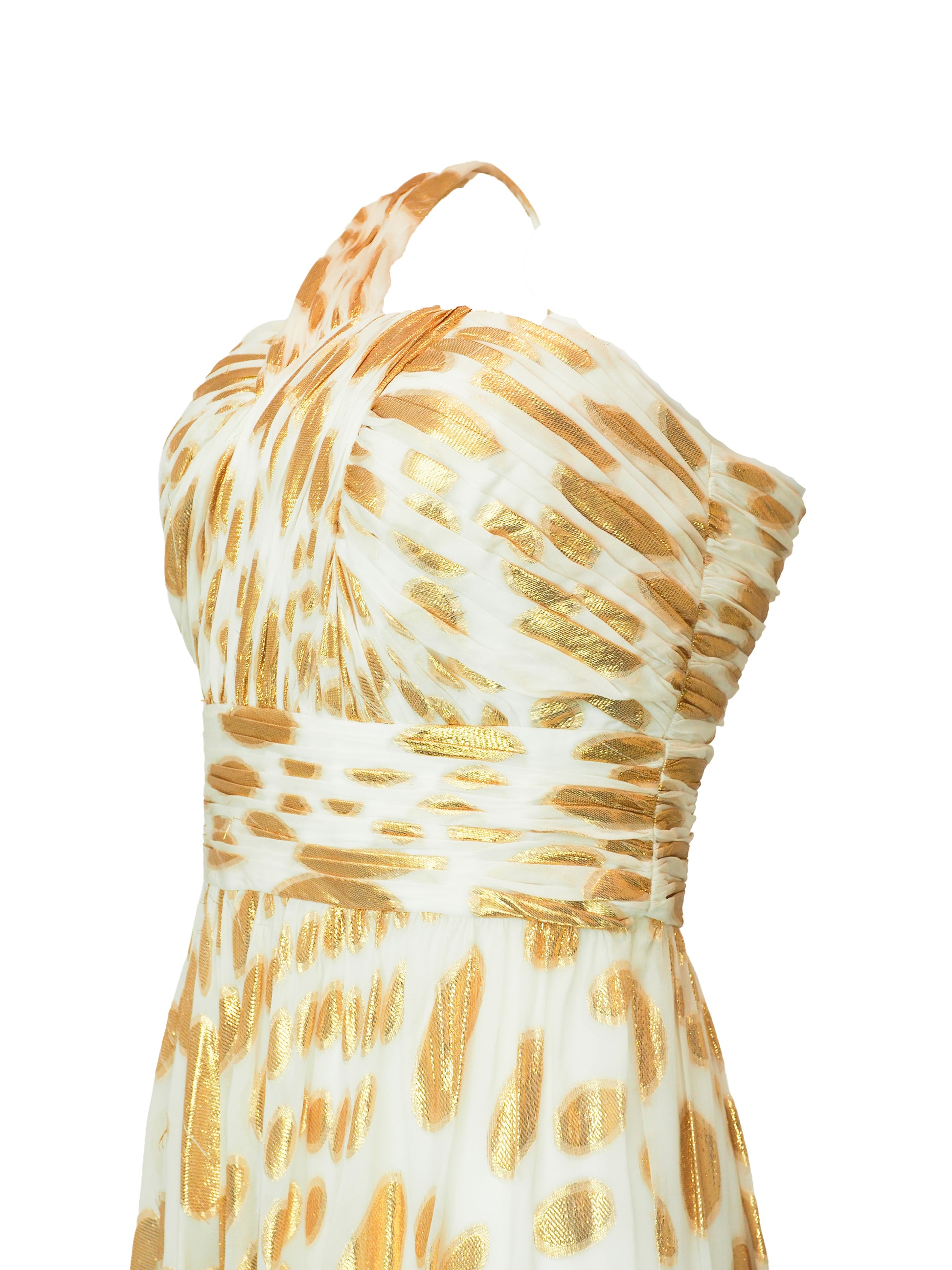 A vintage halter-neck maxi dress with a gold and cream animal print pattern, featuring a ruched bodice and a flowing skirt.