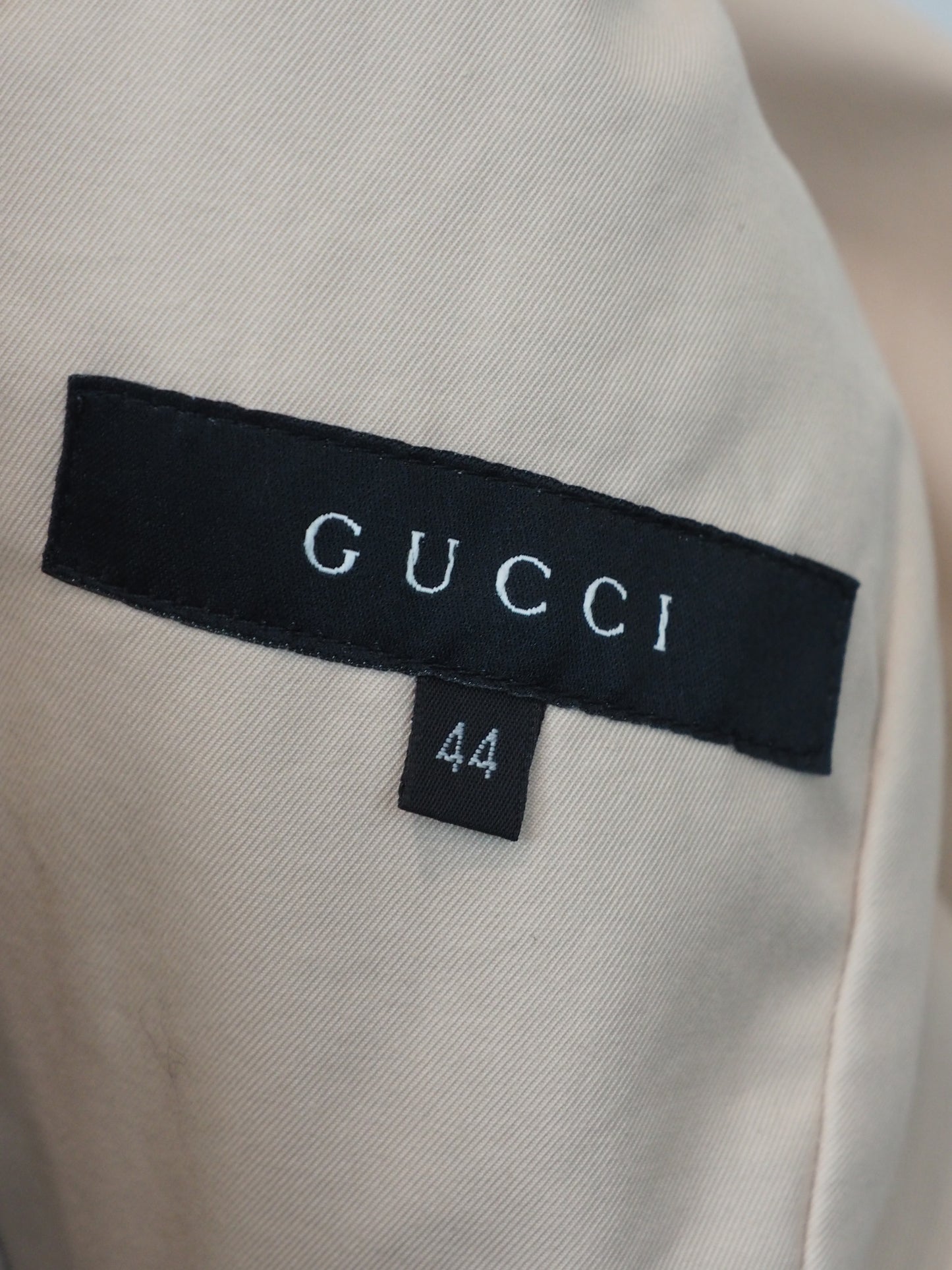 A women's vintage Tom Ford Gucci 2003 beige utility-style blazer jacket with a notched lapel collar, buttoned flap chest pockets, a gathered waist seam, and two large front flap pockets