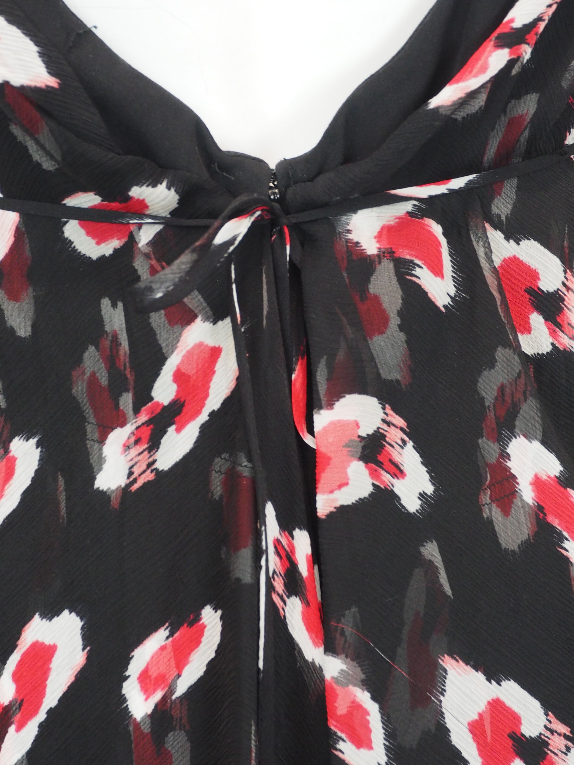 A vintage Carolina Herrera chiffon sleeveless black maxi dress with a red and pink floral print, featuring a halter-style neckline and a tie-waist detail, shown against a plain white background.