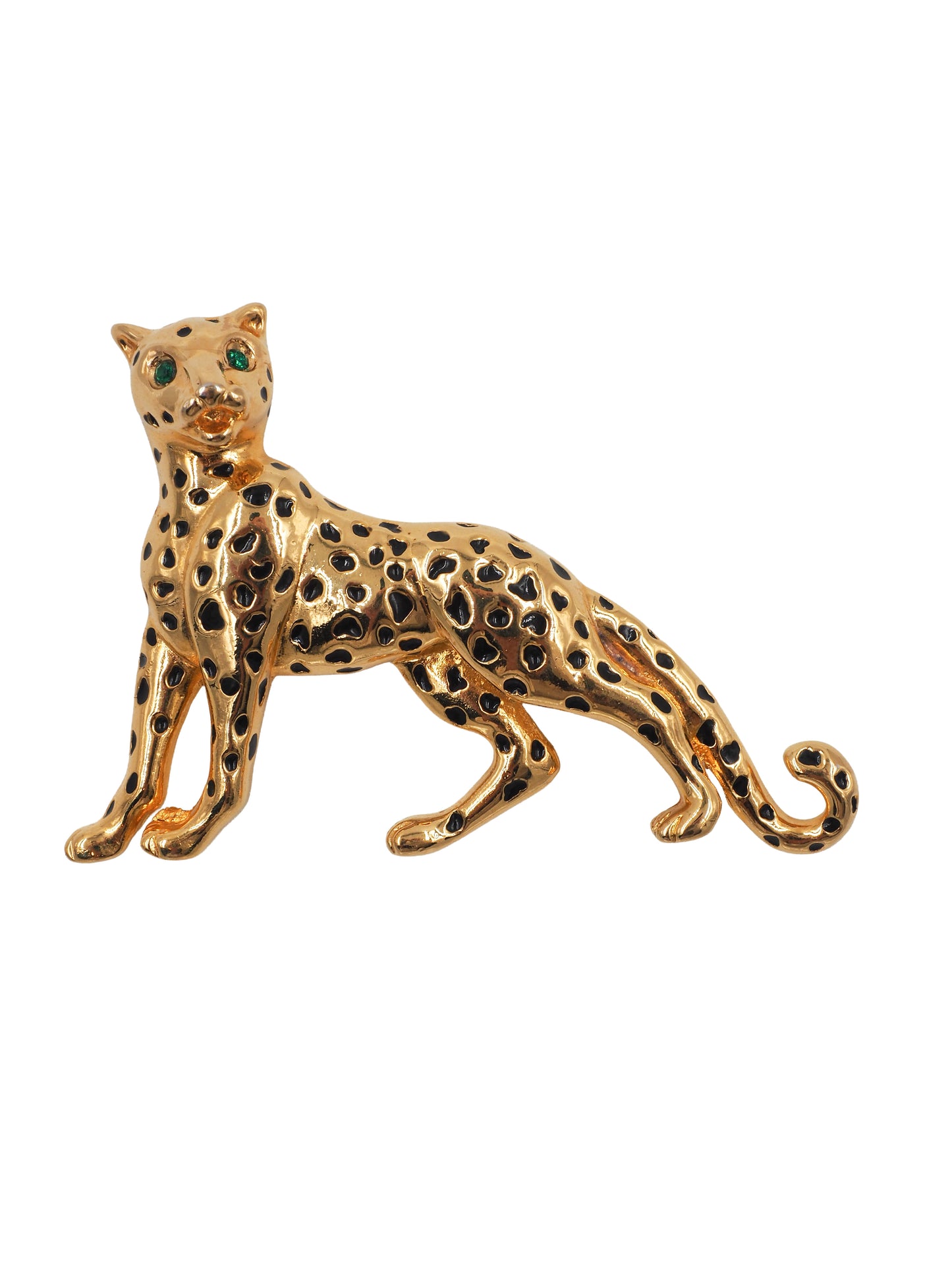 A vintage gold leopard-shaped brooch with black enamel spots and green gemstone eyes
