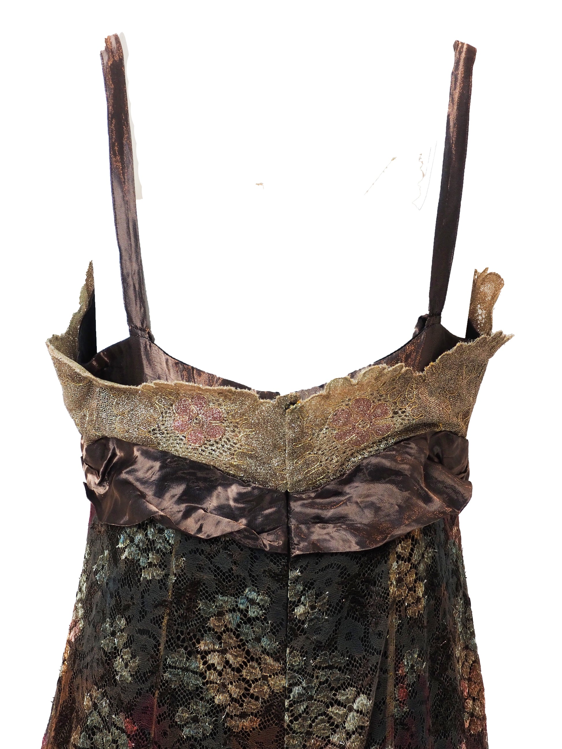 A vintage christian Lacroix runway sleeveless maxi dress with a sheer floral lace pattern in earthy tones of brown, green, and gold, featuring a cream lace bodice and a dark brown satin waist tie