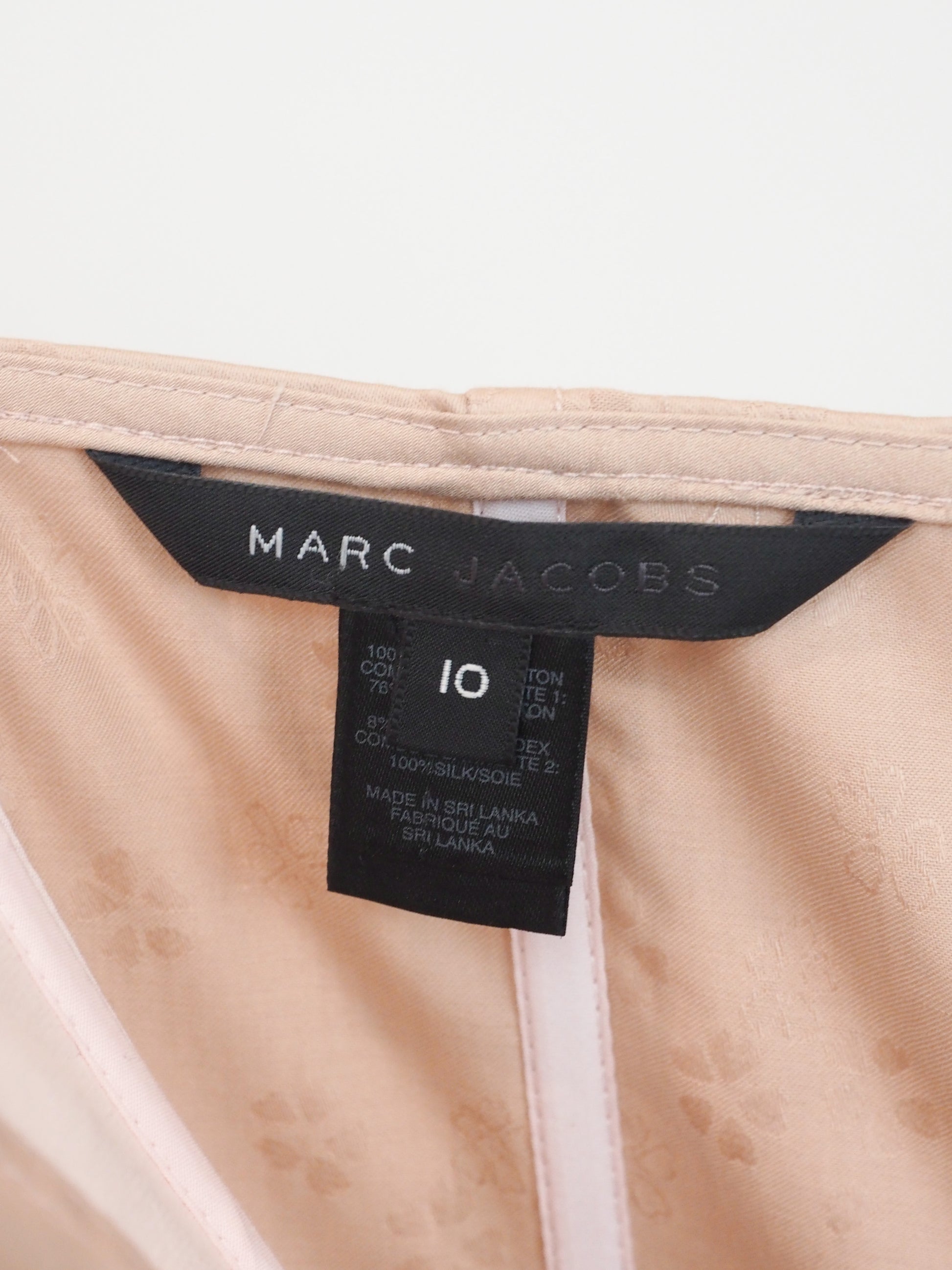 A vintage Marc Jacobs beige and light pink corset-style mini dress with thin shoulder straps, a front zipper, side lace-up detailing, and a gathered skirt