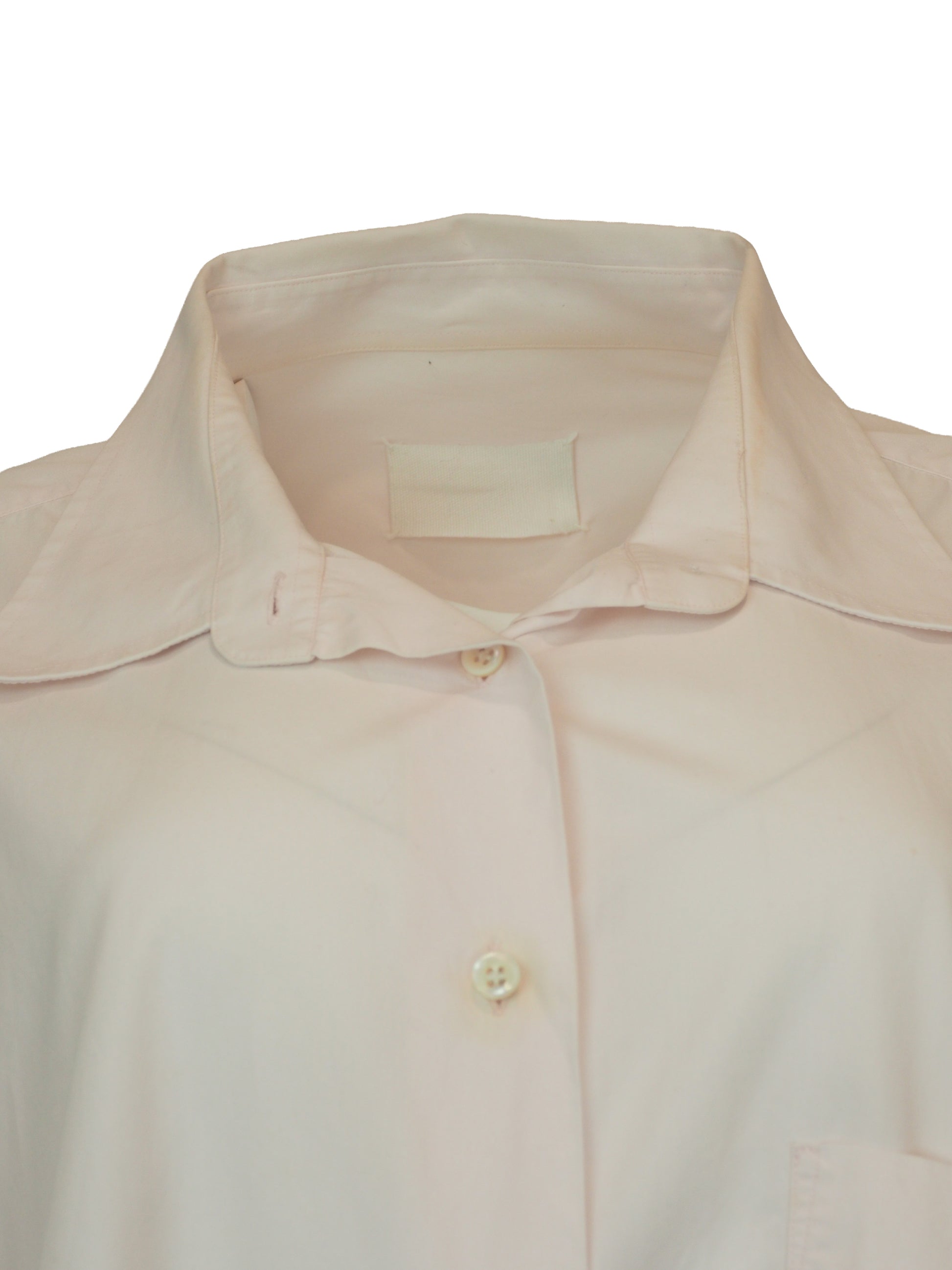 A vintage Maison Martin margiela 2001 pale blush pink oversized button-down shirt dress with a pointed collar, long sleeves, and a small black embroidered clover on the left chest