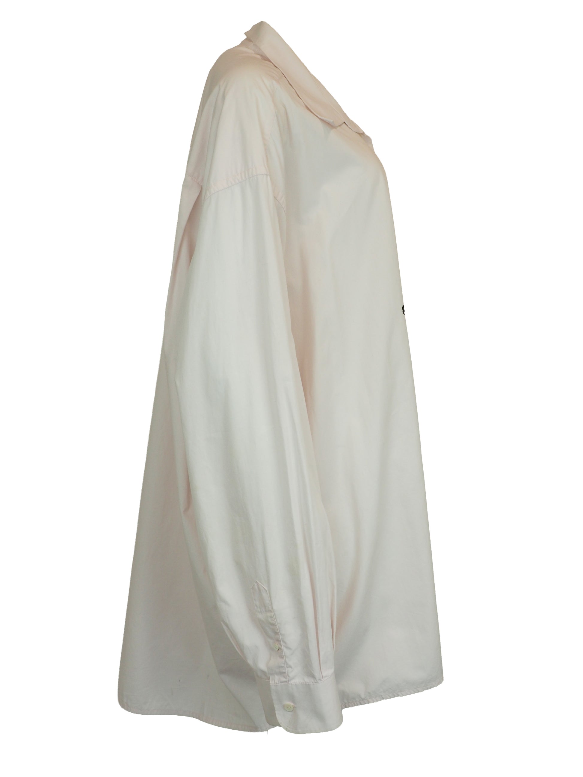  A vintage Maison Martin margiela 2001 pale blush pink oversized button-down shirt dress with a pointed collar, long sleeves, and a small black embroidered clover on the left chest