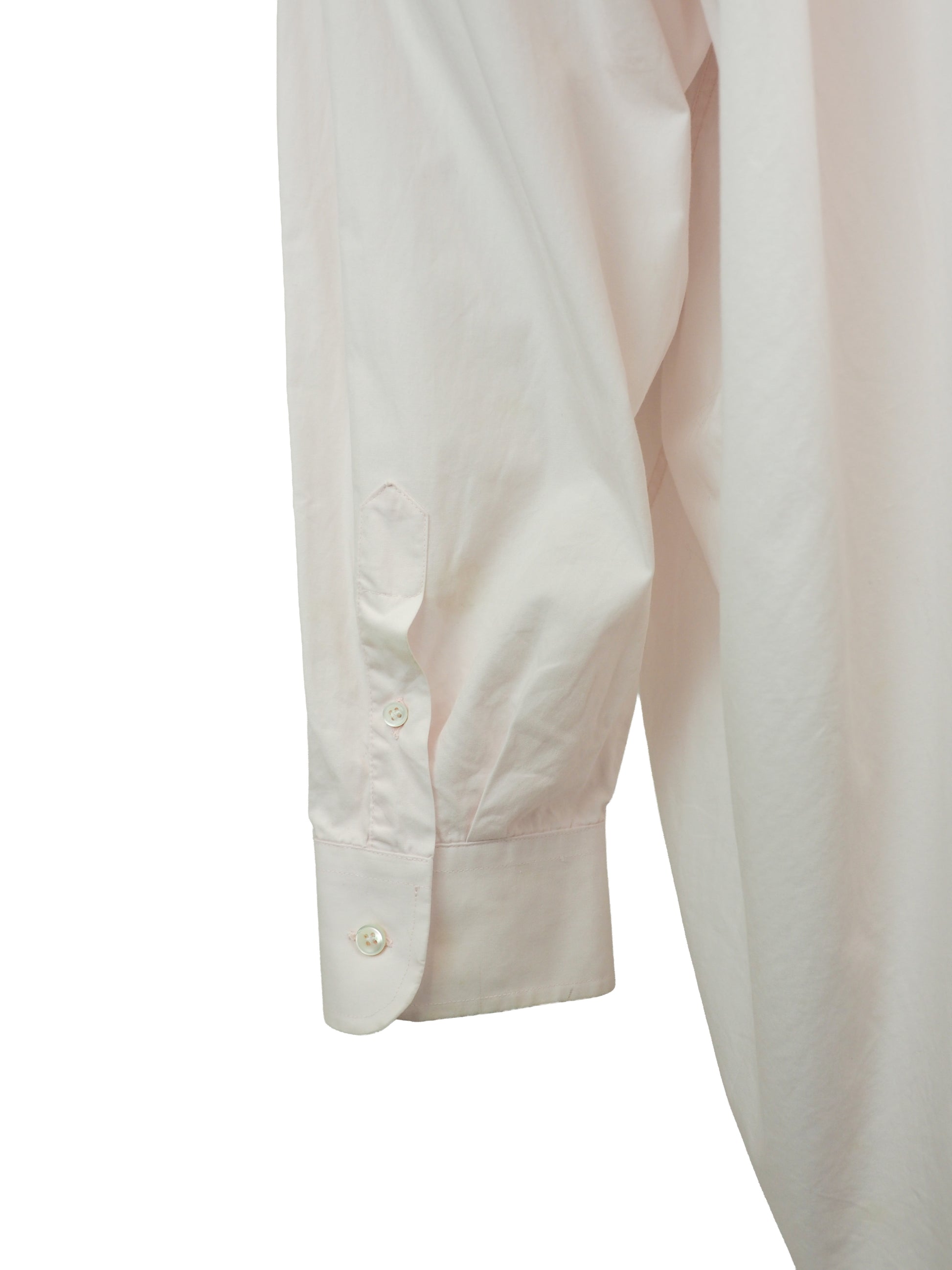 A vintage Maison Martin margiela 2001 pale blush pink oversized button-down shirt dress with a pointed collar, long sleeves, and a small black embroidered clover on the left chest