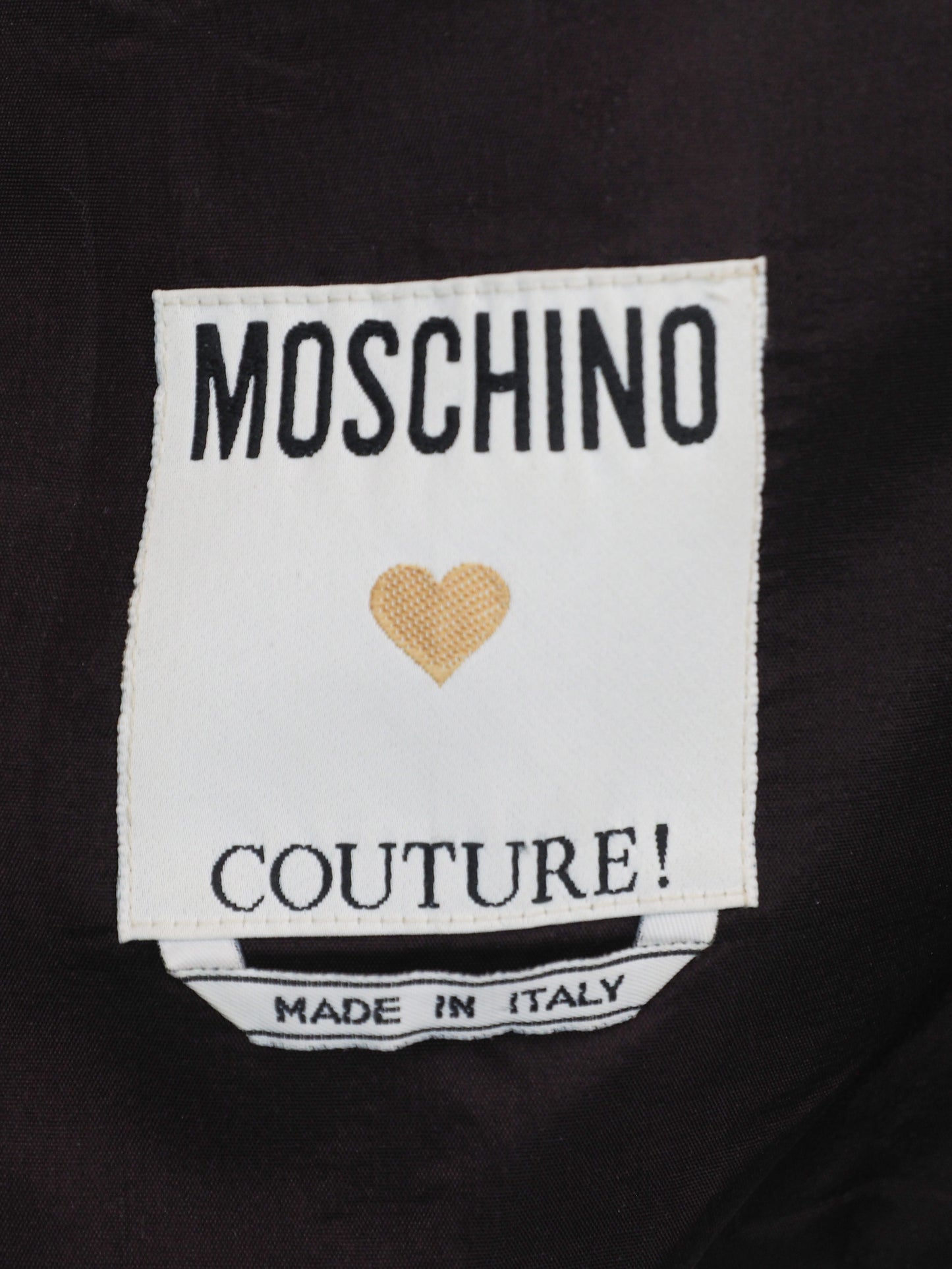 A vintage moschino black camisole top with thin spaghetti straps and a sweetheart neckline, decorated with black beaded fringe trim along the neckline 