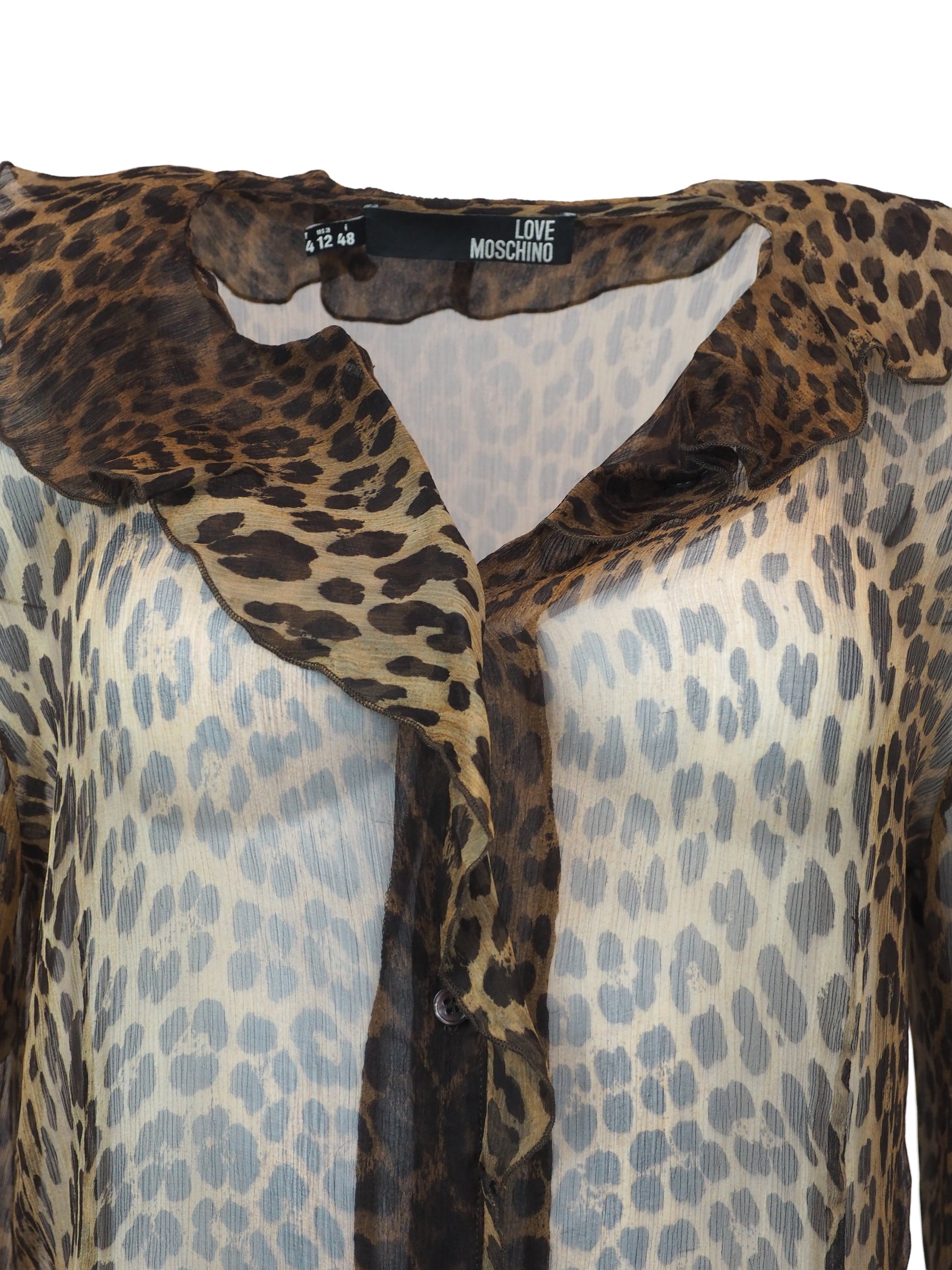 A vintage moschino sheer leopard-print blouse with a ruffled collar, button-front center panel, and matching ruffled cuffs