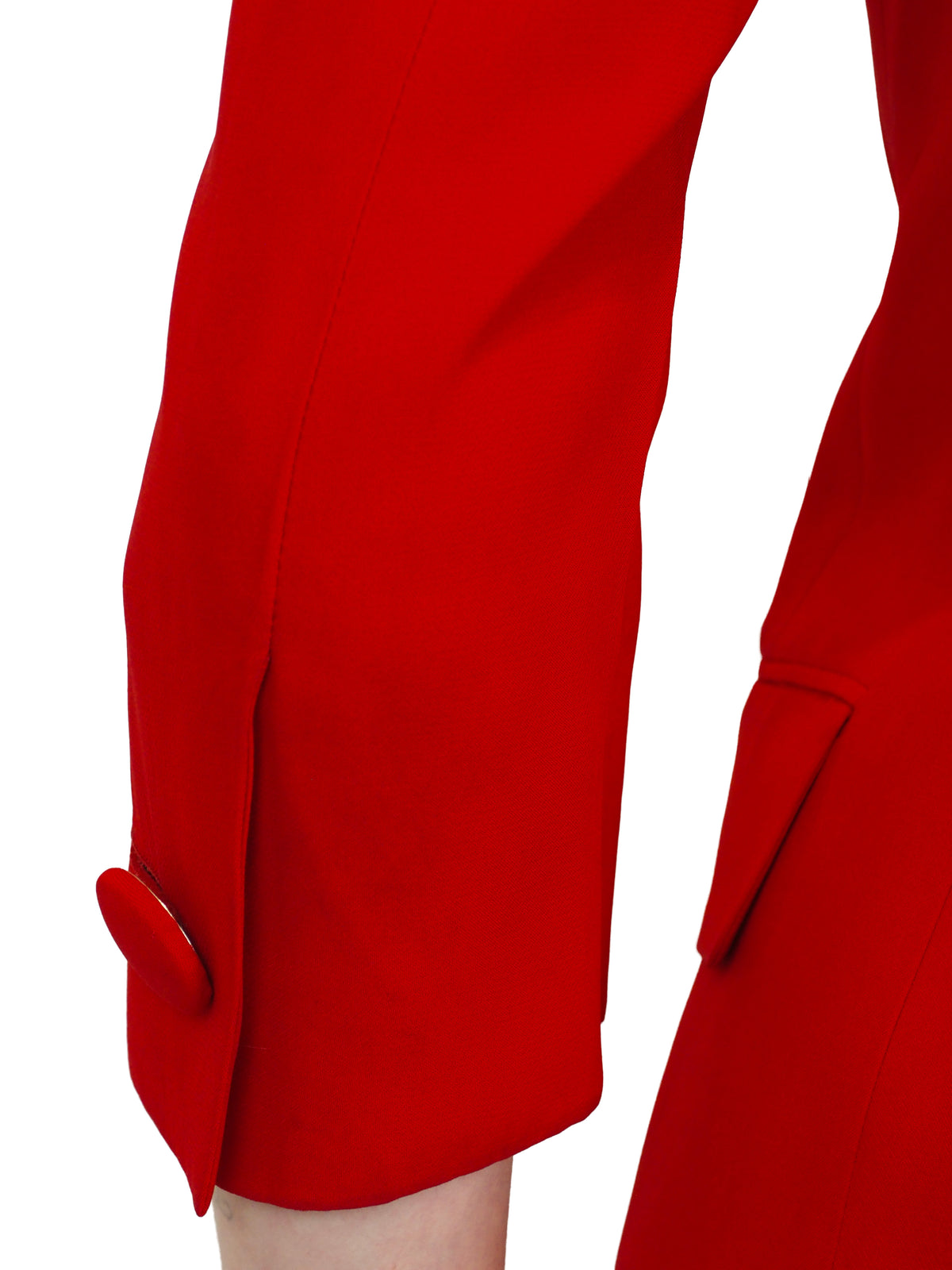 A vintage 1991 moschino bright red two-piece suit with gold lettering reading "waist of money"