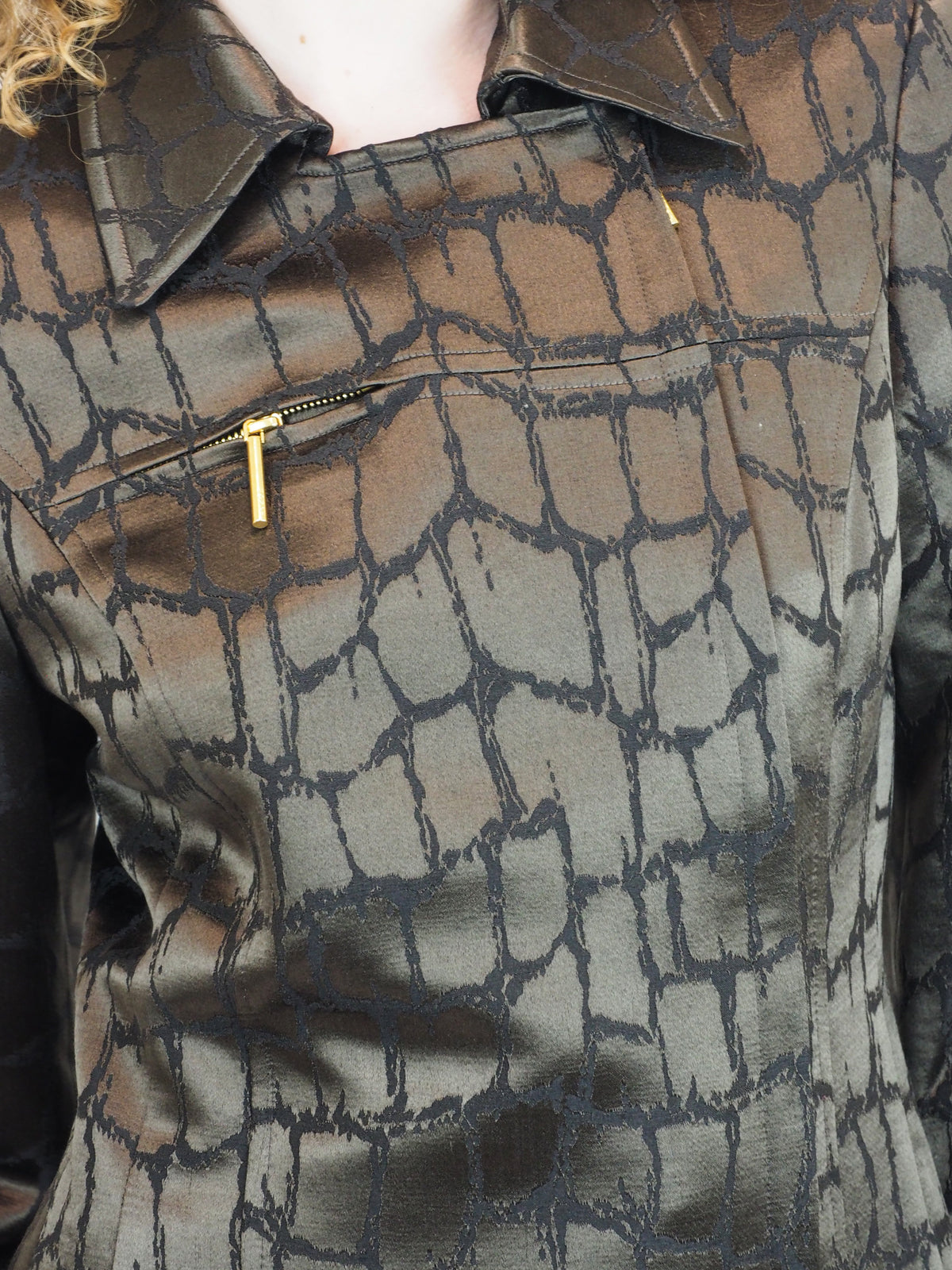A vintage 1980's Mondi matching dark brown and black textured suit with a collared jacket, mini skirt and trousers