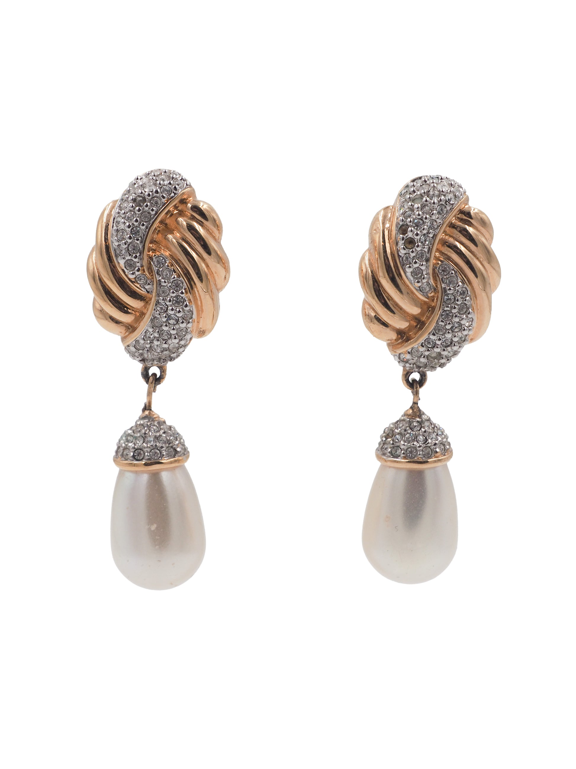 A pair of vintage gold and silver drop earrings featuring a twisted knot design paved with clear stones, with a teardrop-shaped white pearl hanging below each earring