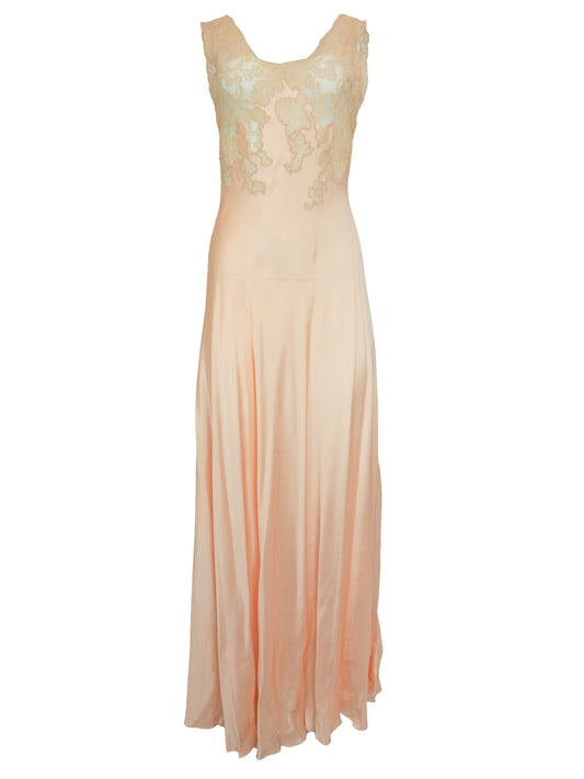 A vintage 1920s 1930s sleeveless peach maxi slip dress with a satin-like skirt and a light ivory lace embroidered bodice