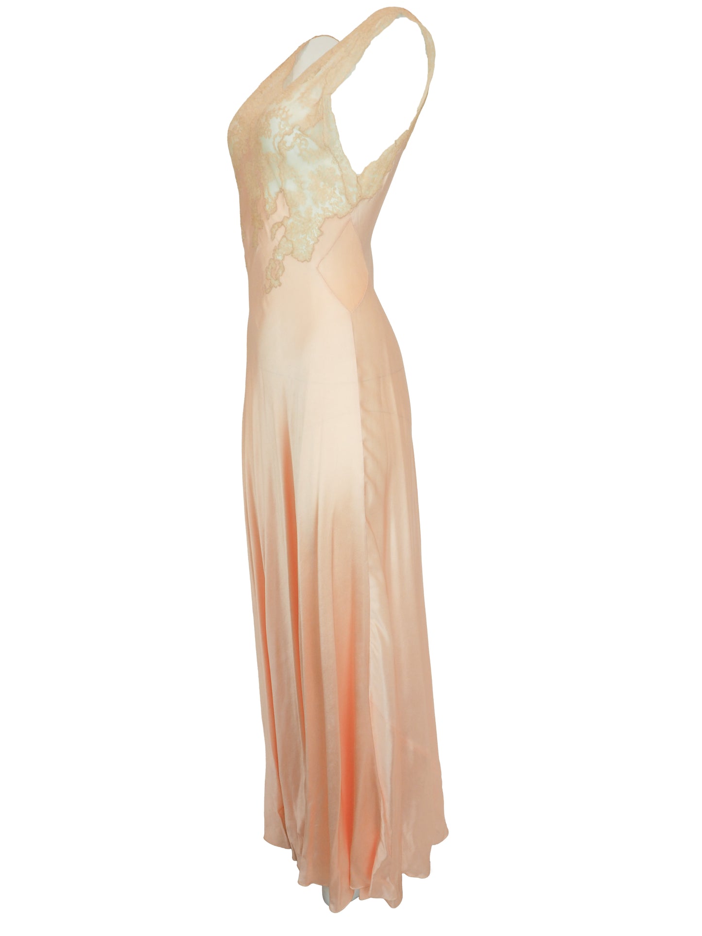 A vintage 1920s 1930s sleeveless peach maxi slip dress with a satin-like skirt and a light ivory lace embroidered bodice
