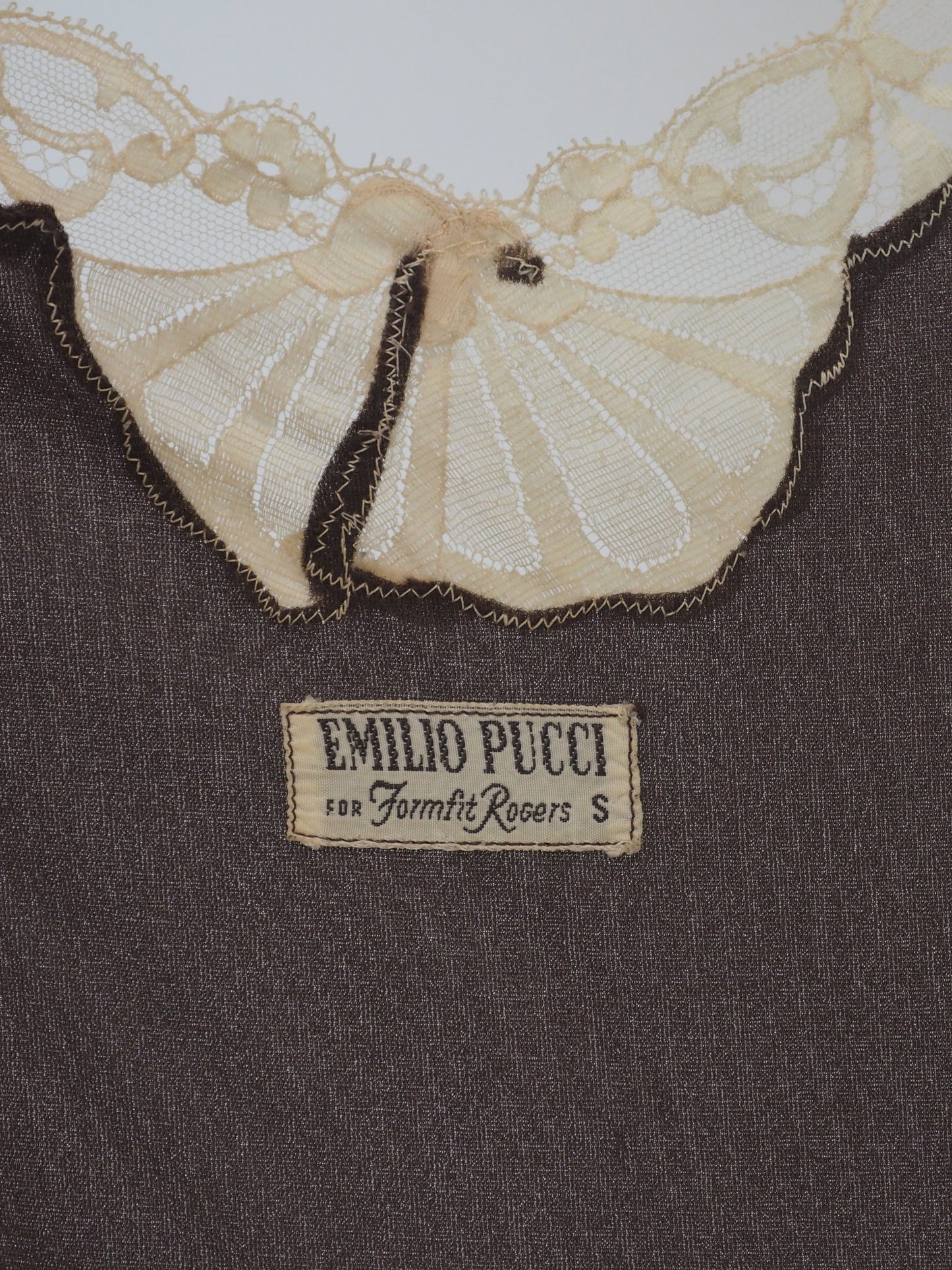 A vintage Emilio Pucci 1960s dark brown long-sleeved nightgown with cream lace trim along the edges, collar, and cuffs