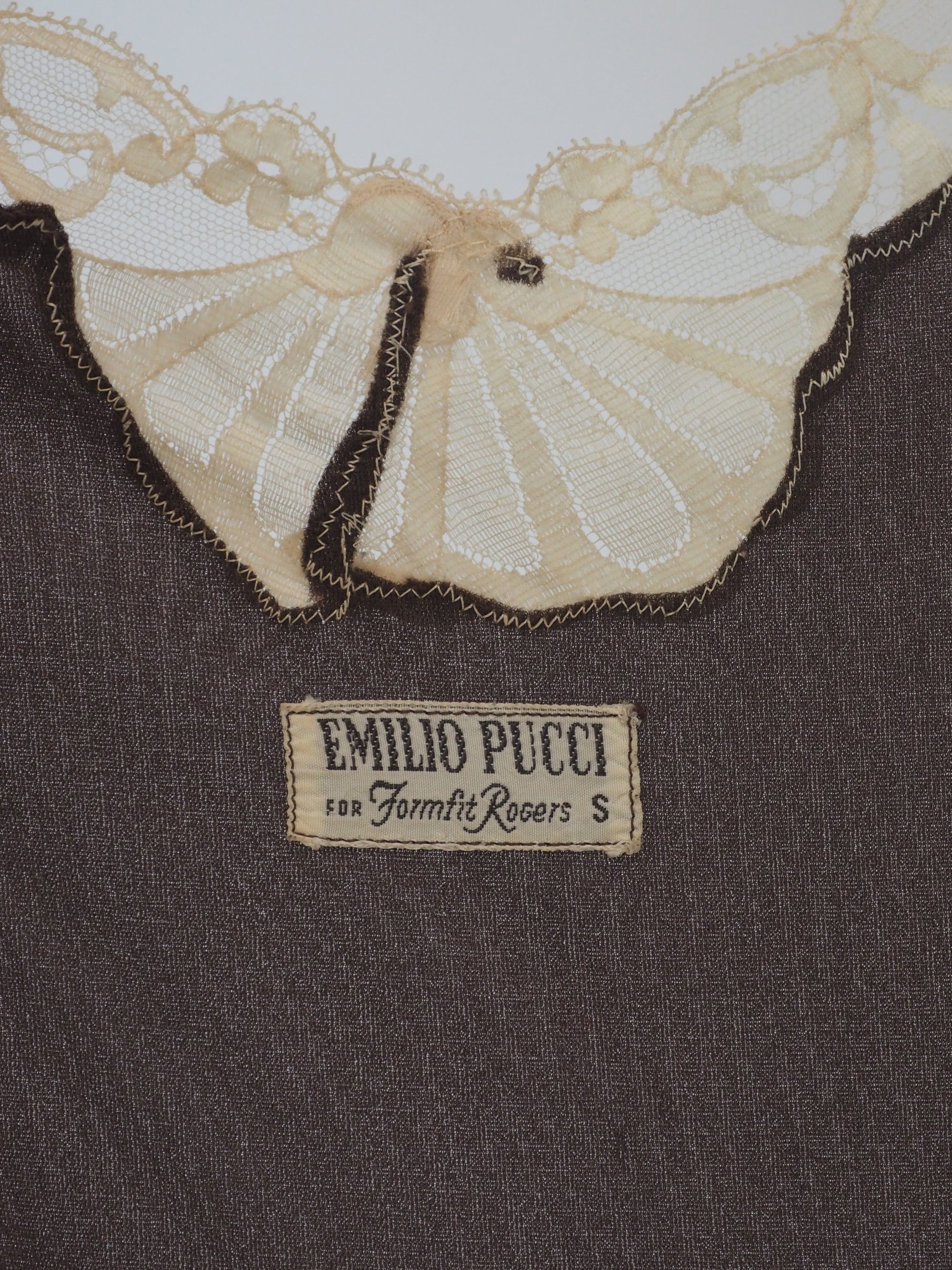A vintage Emilio Pucci 1960s dark brown long-sleeved nightgown with cream lace trim along the edges, collar, and cuffs