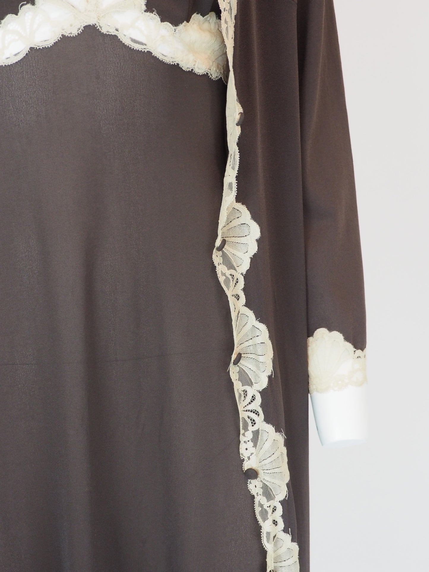 A vintage Emilio Pucci 1960s dark brown long-sleeved nightgown with cream lace trim along the edges, collar, and cuffs