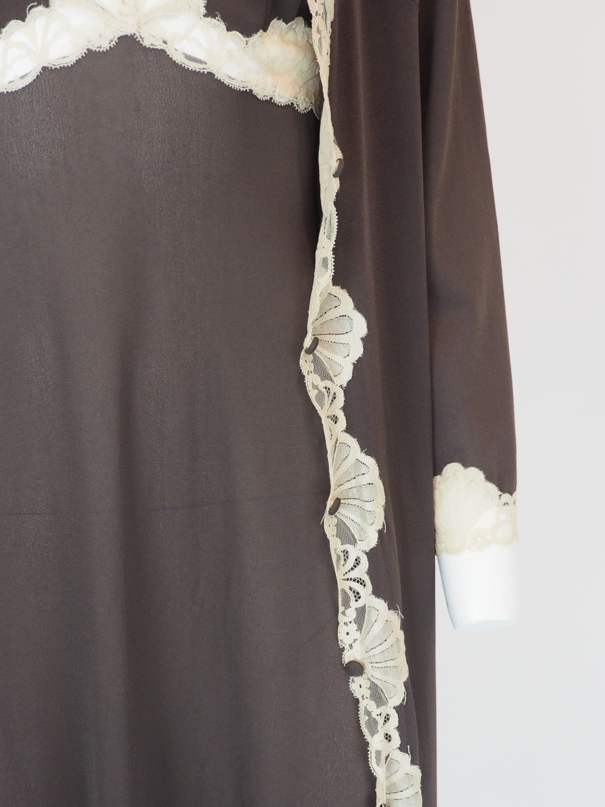 A vintage Emilio Pucci 1960s dark brown long-sleeved nightgown with cream lace trim along the edges, collar, and cuffs