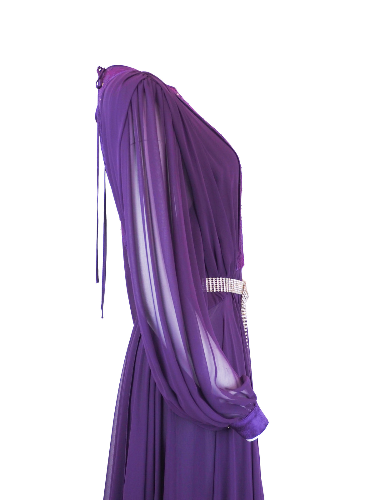 A vintage long-sleeved purple maxi dress with a sheer mesh overlay, a sequined embroidered bodice, and a silver rhinestone-embellished belt