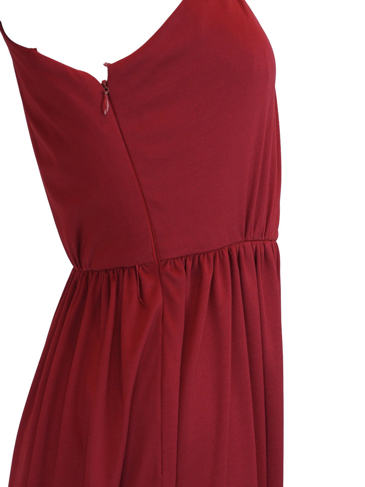 A vintage 1970s red one-shoulder maxi dress with a draped, wrap-style bodice and a matching waist tie