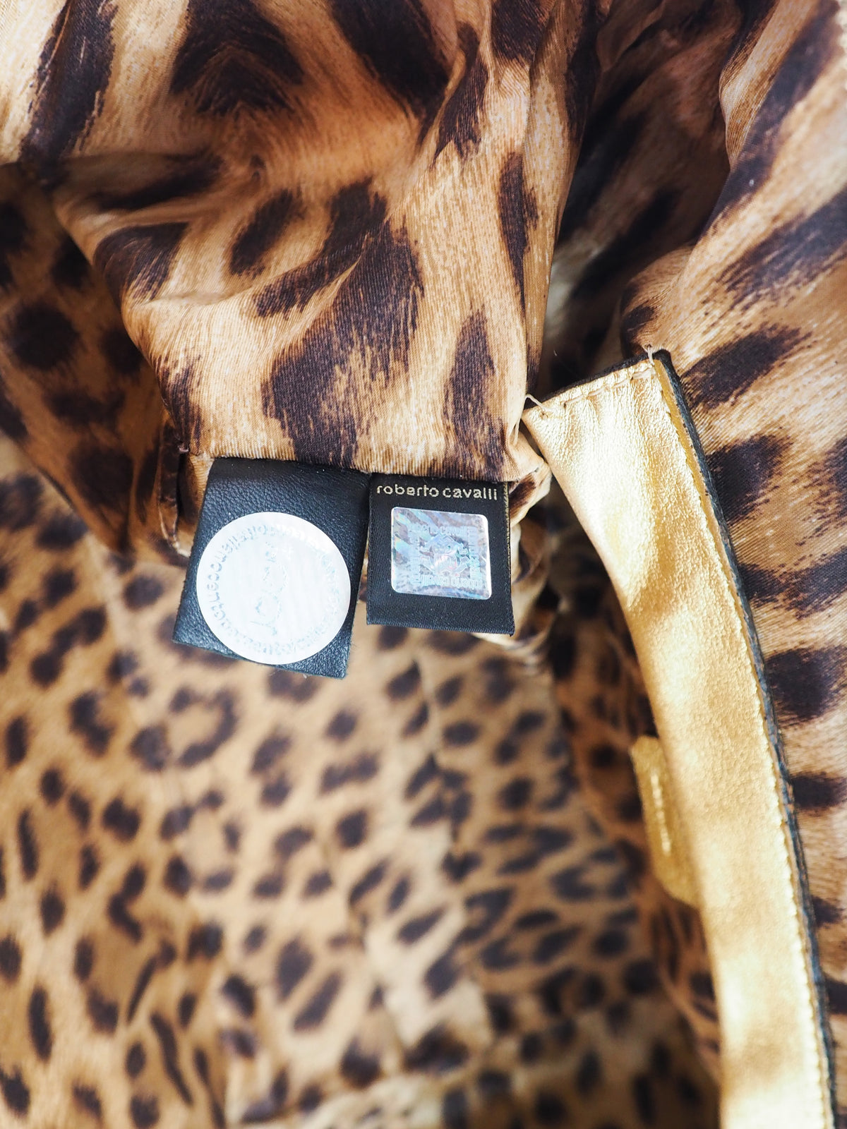 A vintage Roberto cavalli brown leather duffel-style handbag with rope handles and gold-tone hardware