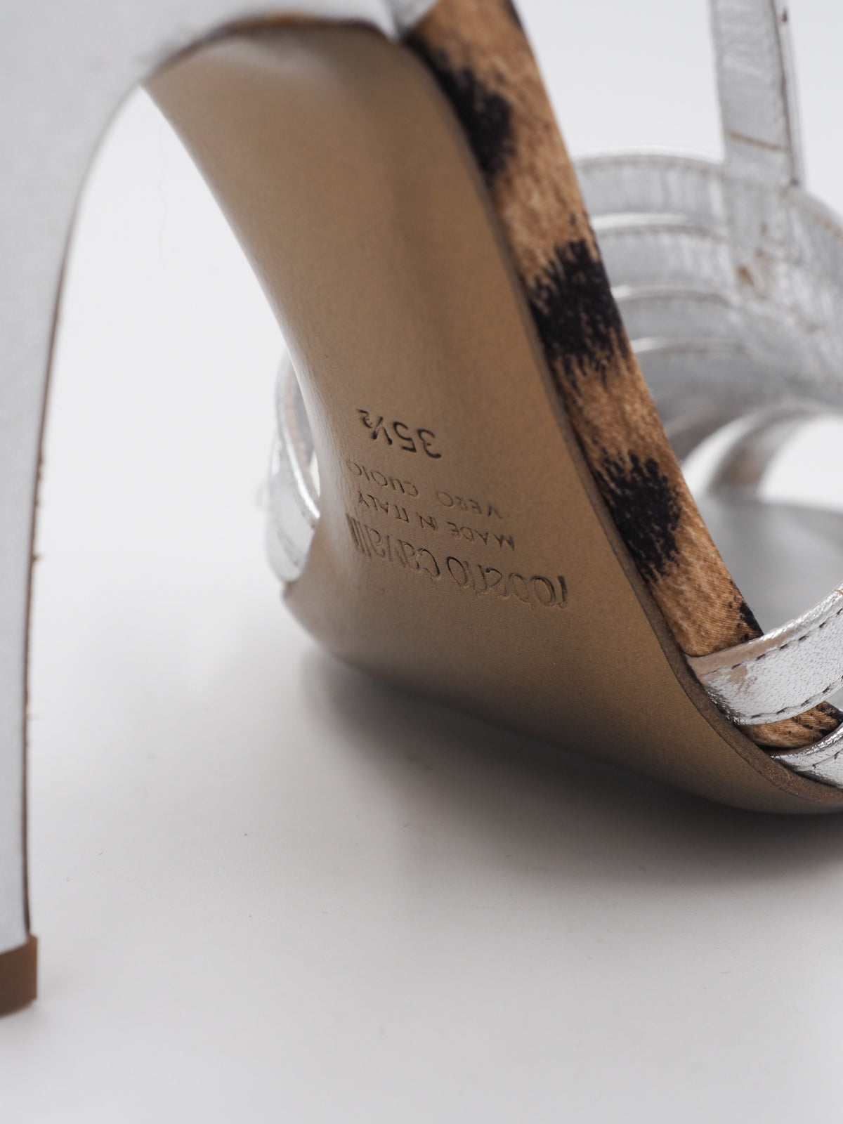 A pair of vintage Roberto cavalli metallic silver strappy high-heeled sandals with T-strap details and stiletto heels