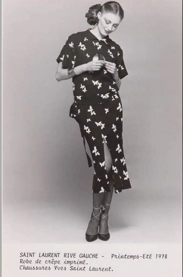 A vintage Yves Saint Laurent YSL 1970's black short-sleeve midi dress with a white bird pattern