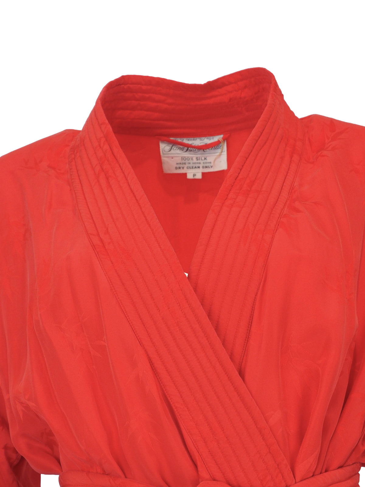 A vibrant red wrap robe with a matching waist tie belt, featuring a subtle tonal floral jacquard pattern near the lower hem