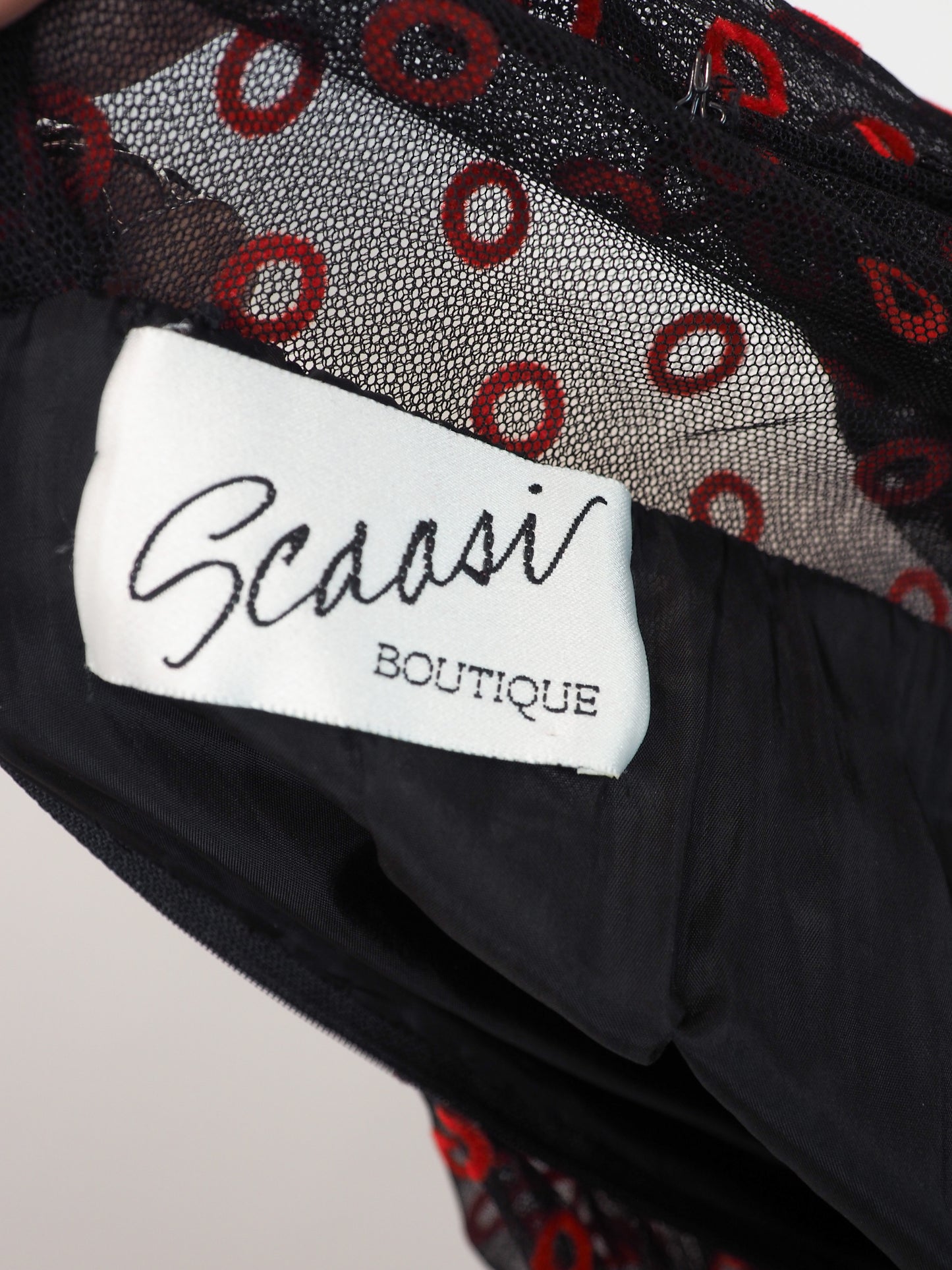 A vintage Arnold Scaasi designer black sheer mesh dress with a red and black poppy print, featuring a ruffled high neck, long puff sleeves, and a tiered ruffled skirt