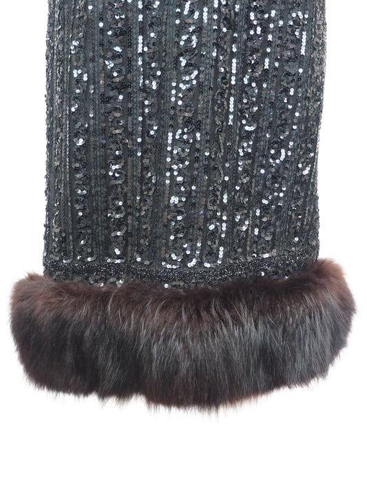 A vintage 1960s black sequined evening dress with short cap sleeves and a brown fox fur-trimmed hem