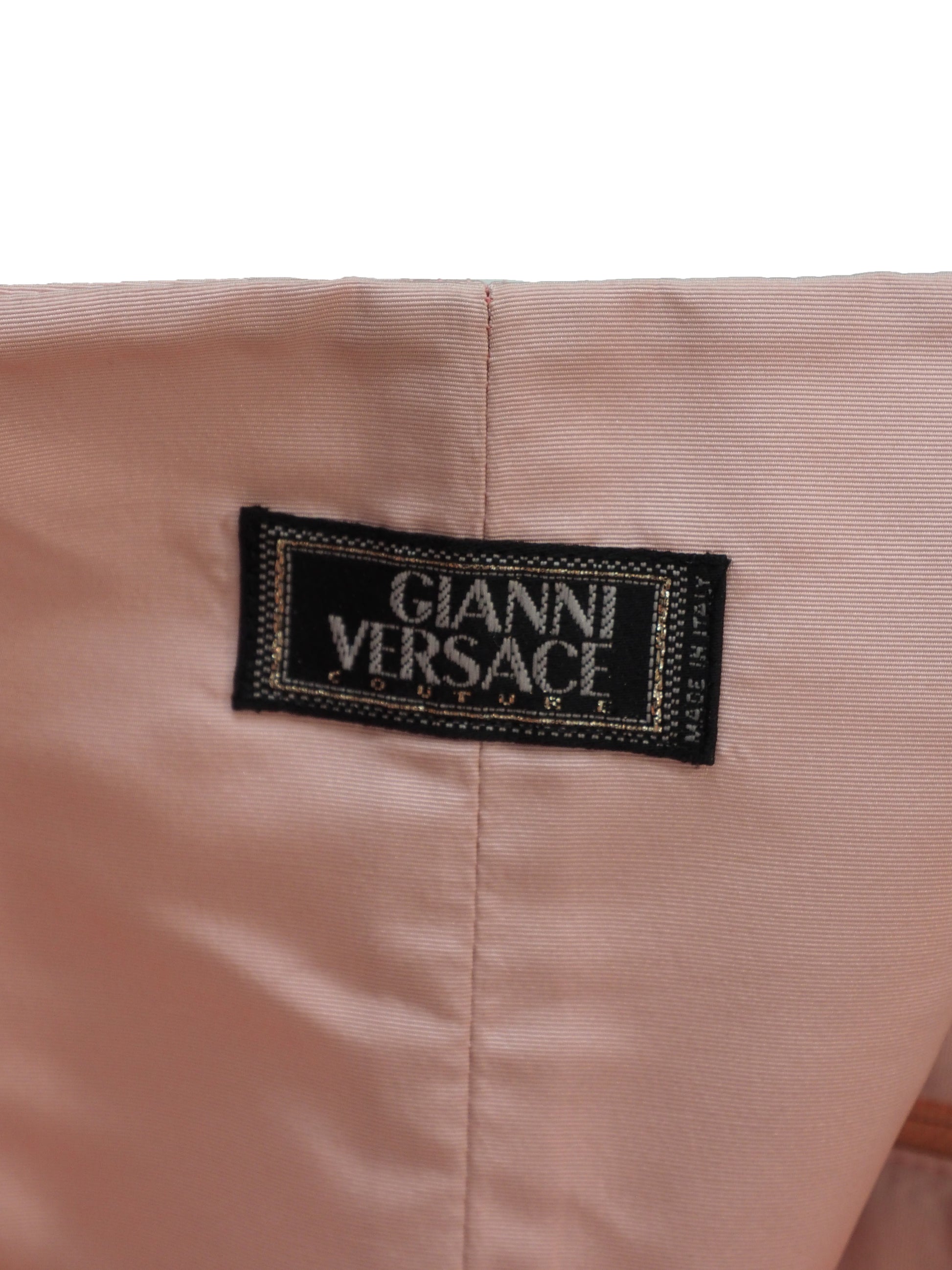 A vintage Versace 1980's light pink structured bustier top with wide shoulder straps, molded cups, and vertical seam detailing