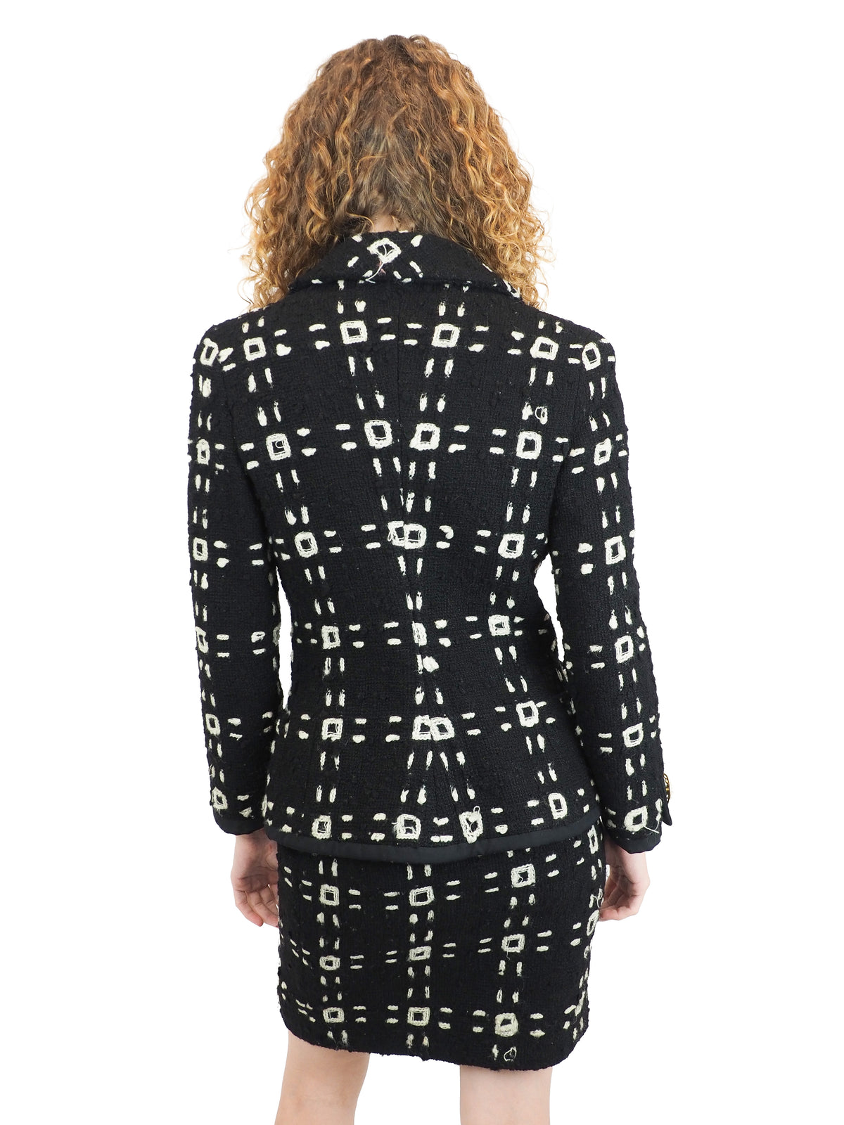 A vintage 1992 Gianni Versace black tweed jacket and matching mini skirt set with a beige geometric pattern and gold buttons