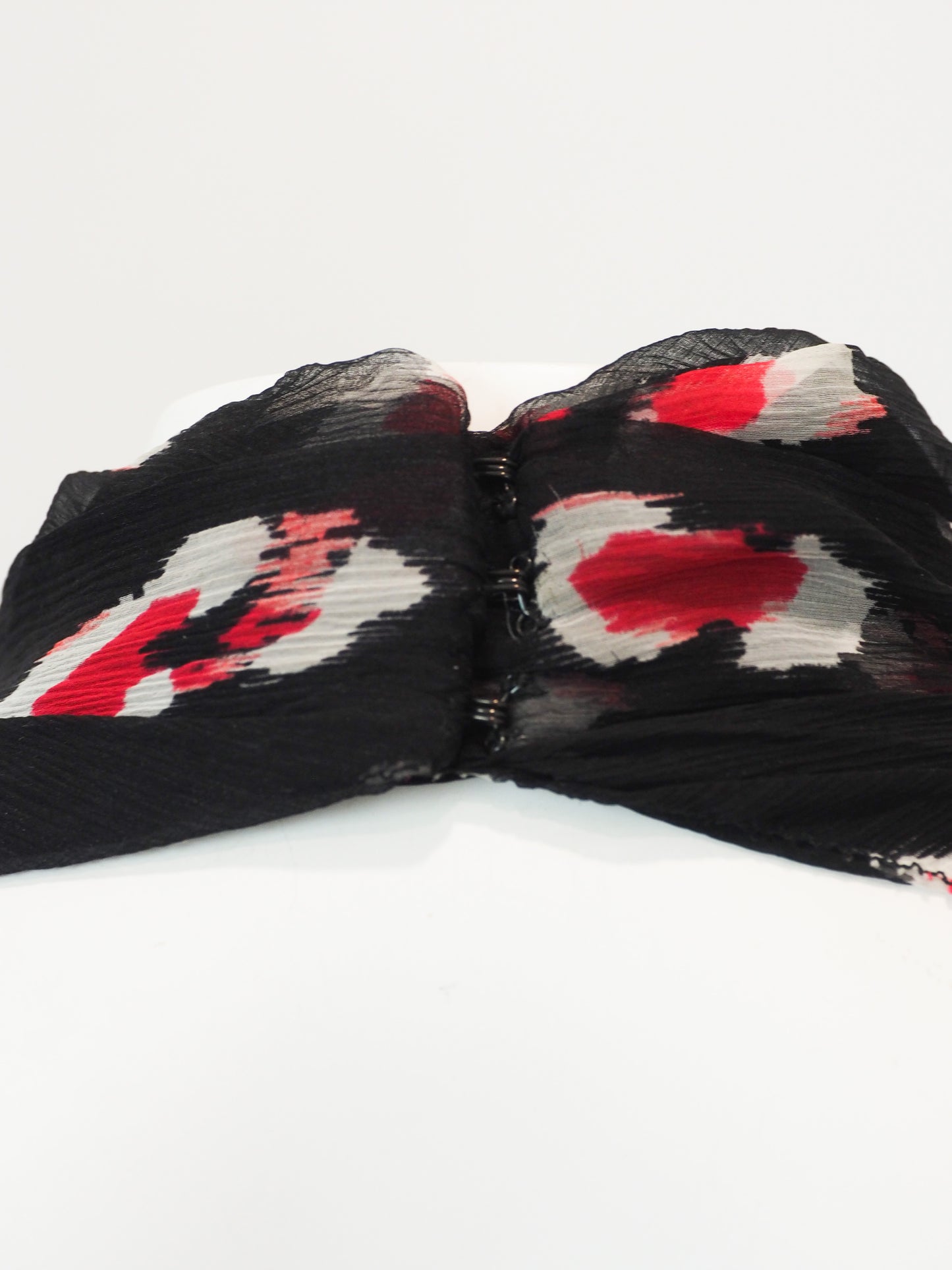 A vintage Carolina Herrera chiffon sleeveless black maxi dress with a red and pink floral print, featuring a halter-style neckline and a tie-waist detail, shown against a plain white background.