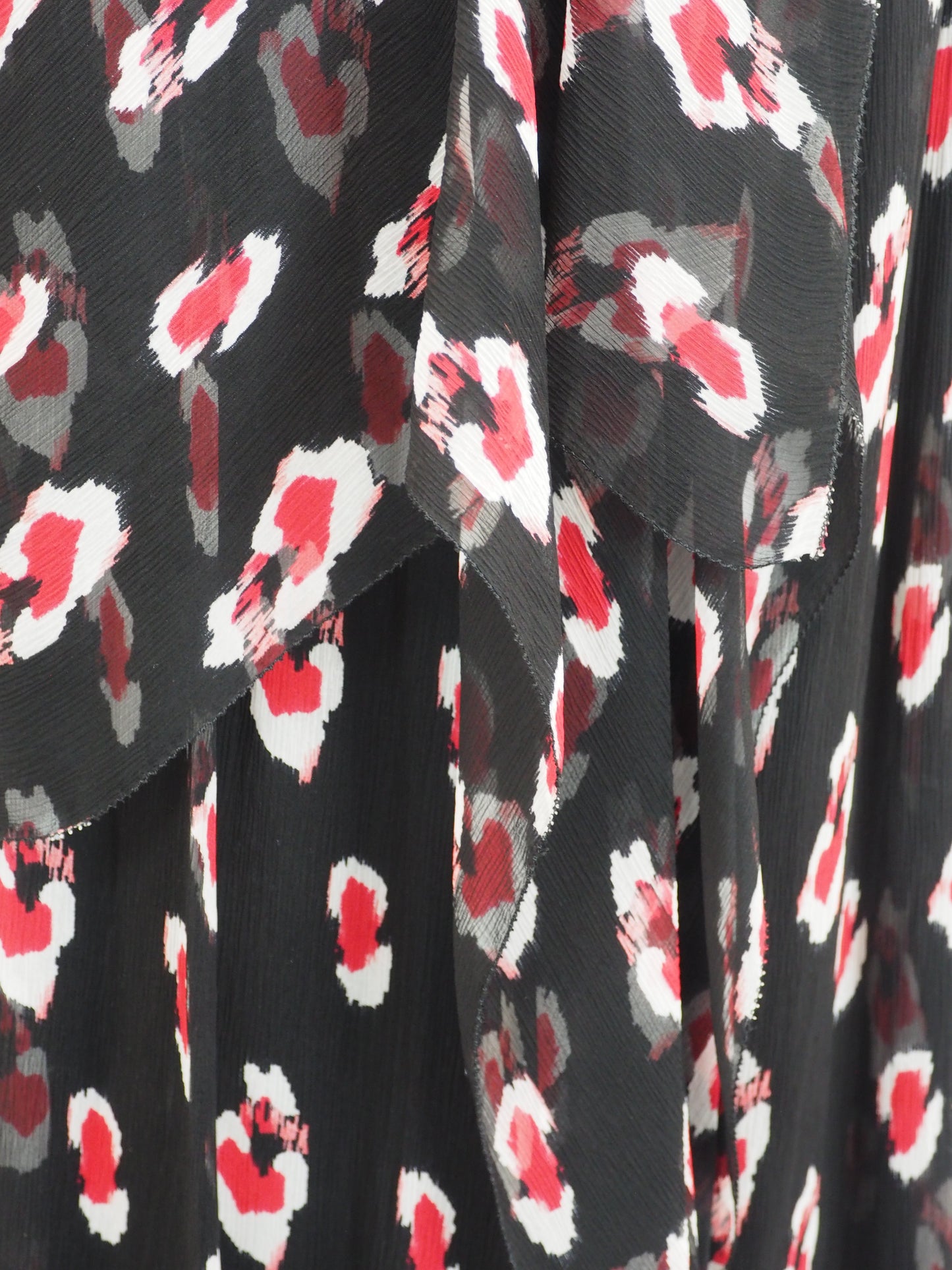 A vintage Carolina Herrera chiffon sleeveless black maxi dress with a red and pink floral print, featuring a halter-style neckline and a tie-waist detail, shown against a plain white background.
