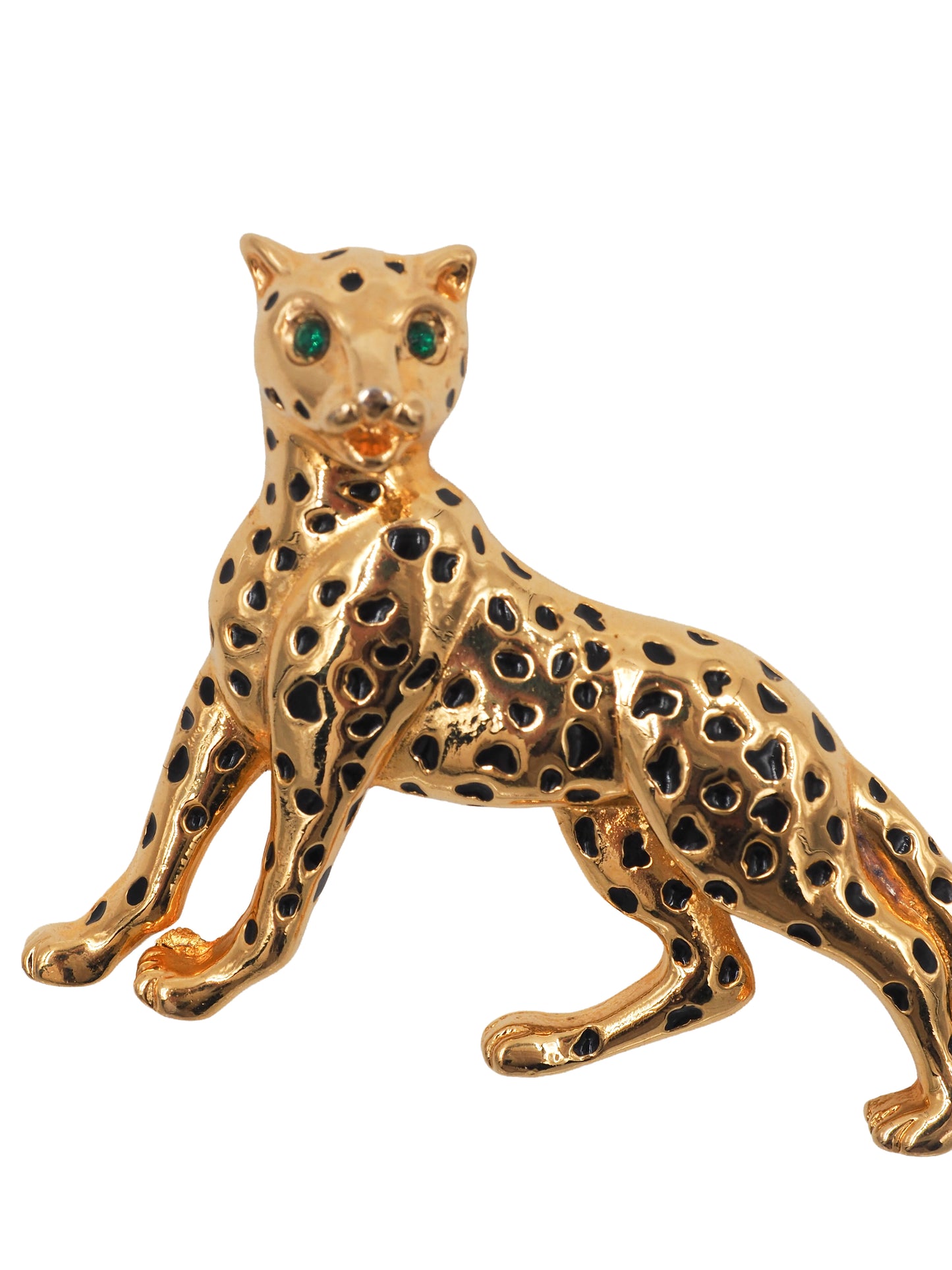 A vintage gold leopard-shaped brooch with black enamel spots and green gemstone eyes