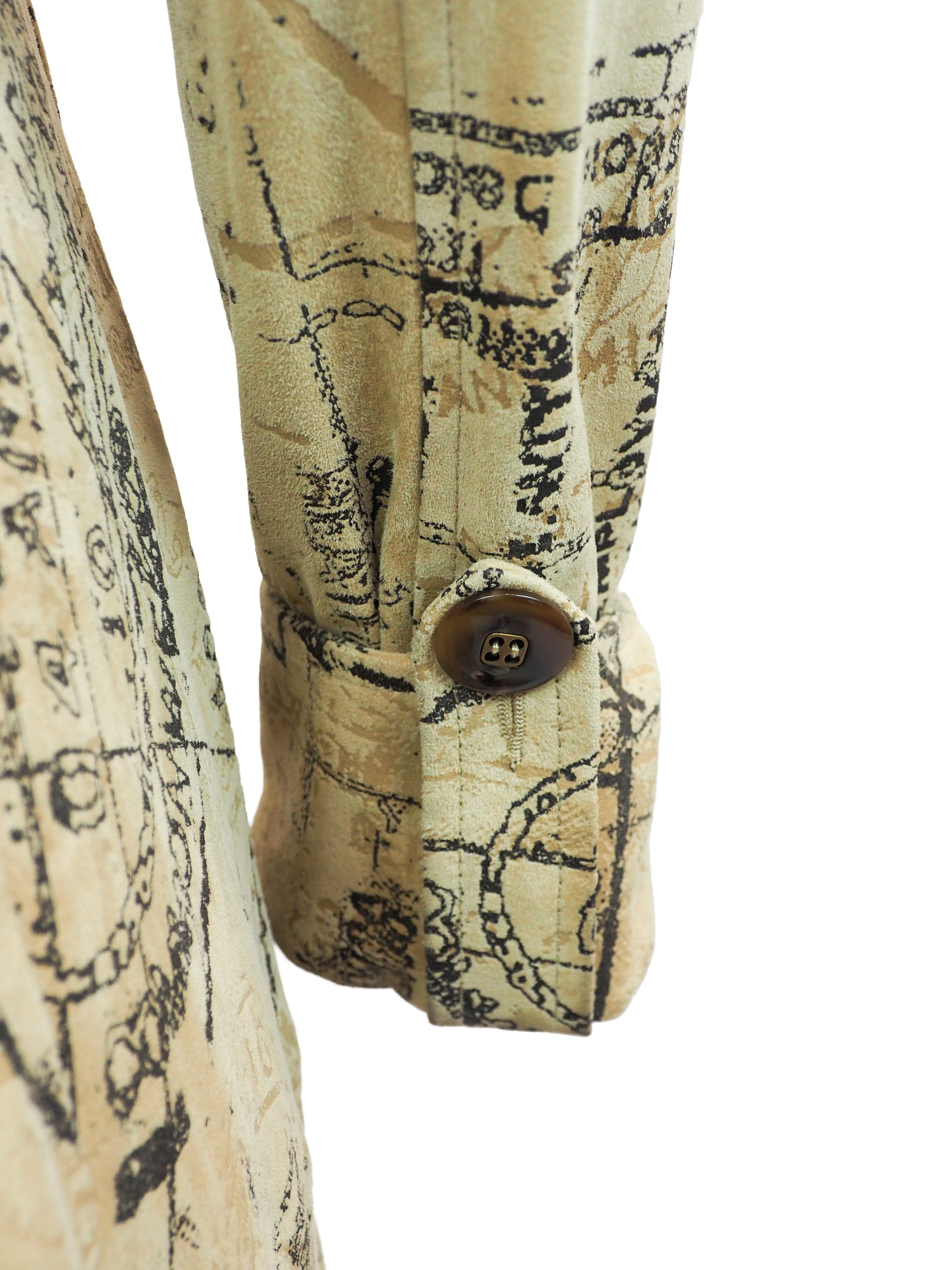 A Diane Von Furstenberg beige trench coat with an all-over black vintage map and script print, featuring a double-breasted design with brown buttons and a matching waist tie, shown against a plain white background.